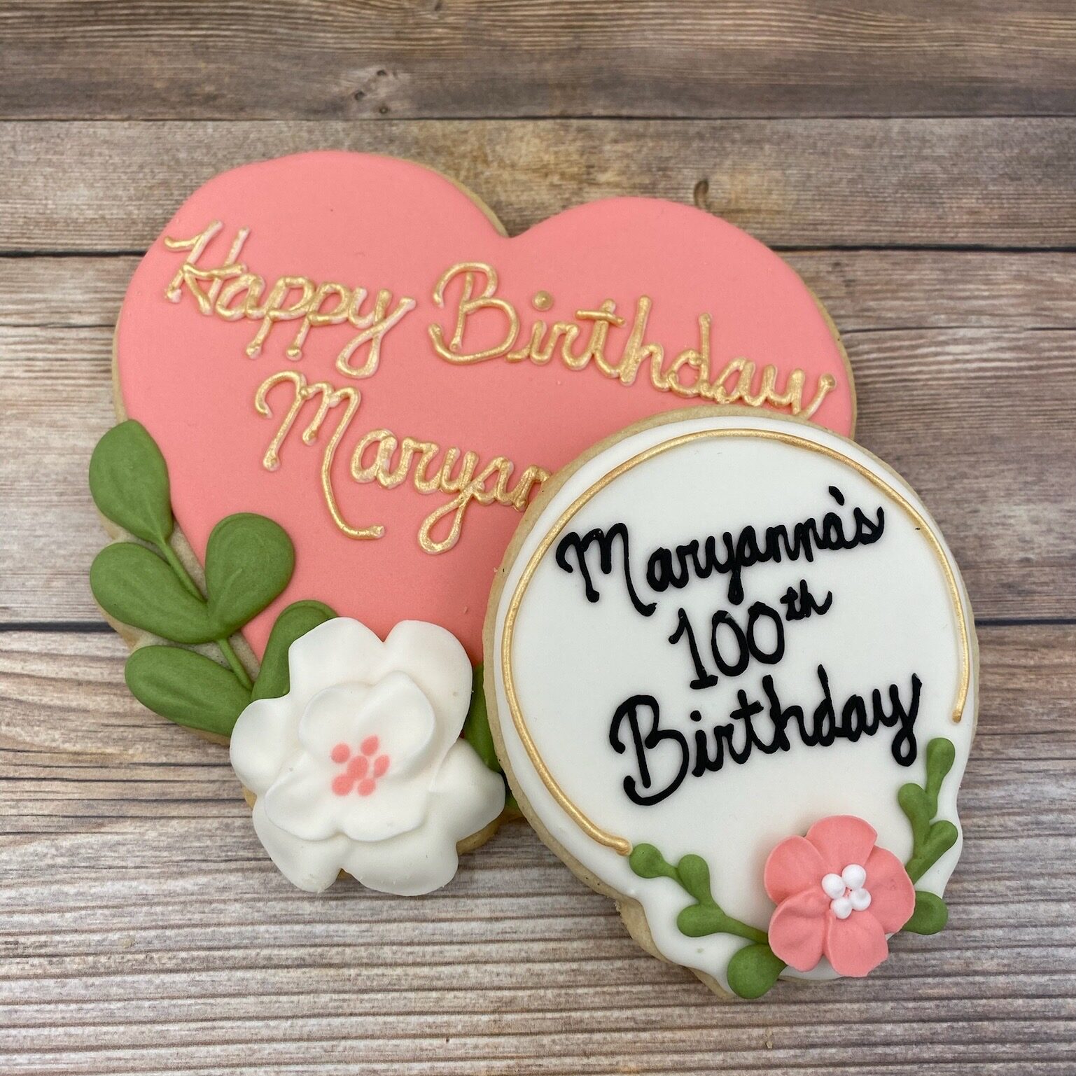 Decorated sugar cookies, a heart and 100th birthday cookie